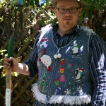 Photo of man in ugly Christmas sweater vest holding a pitchfork