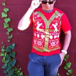 Young man in golf ugly Christmas sweater t-shirt and sunglasses with cross eyes