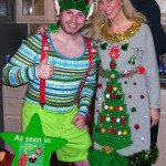 Guy in elf costume and lady in ugly Christmas sweater dress