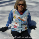 Woman in angel ugly Christmas sweater making snow angels