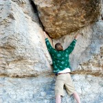 Climbing rocks, in an ugly Christmas sweater