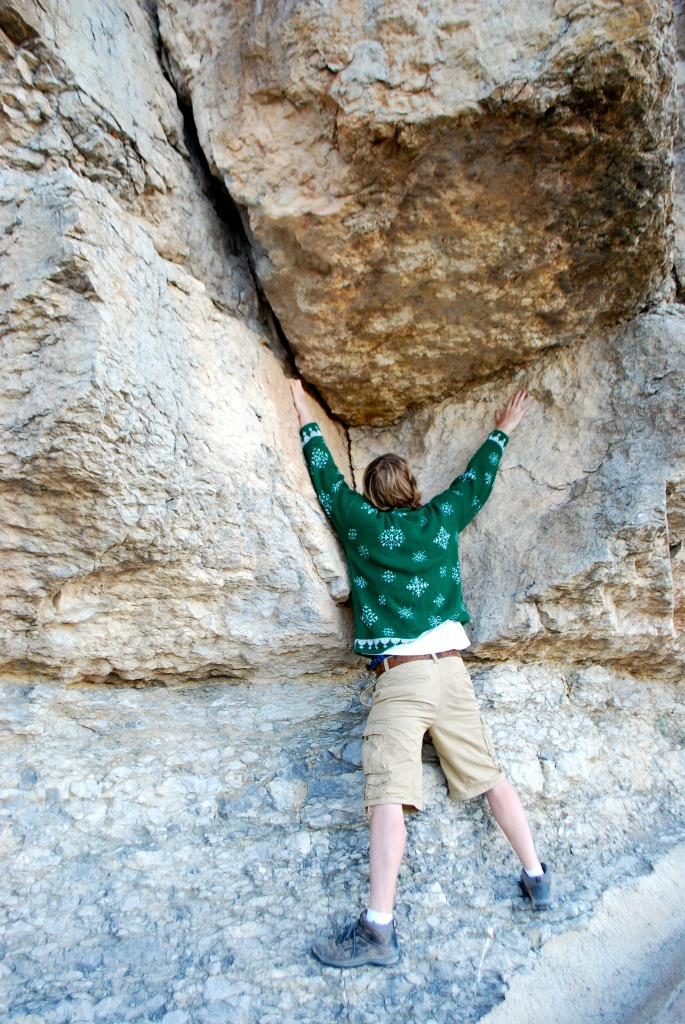 Climbing rocks, in an ugly Christmas sweater