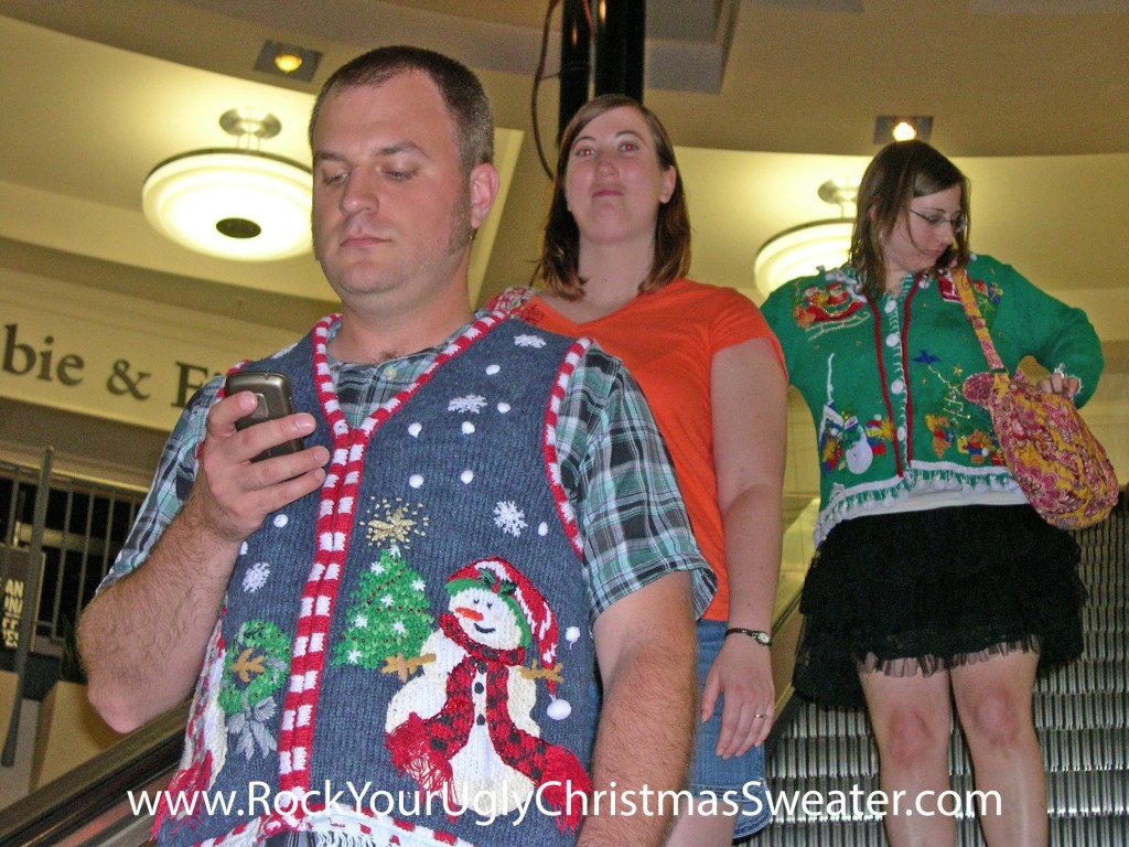 Riding an escalator in ugly Christmas sweaters