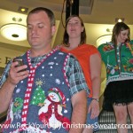 Riding an escalator in ugly Christmas sweaters