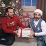 Twins fight over a present under tree in ugly Christmas sweaters